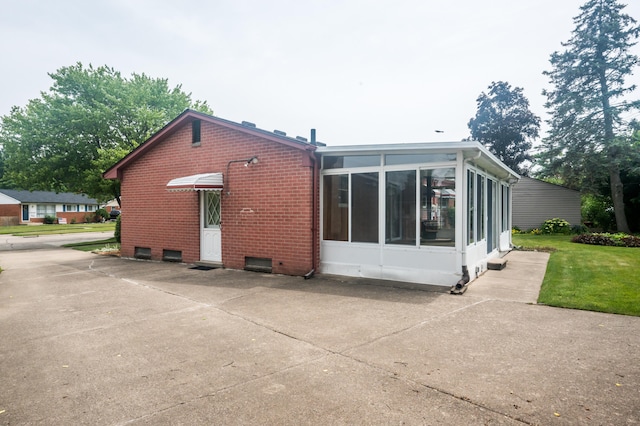 36067 Rolf St, Westland, MI 48186 - rear view of property with a sunroom, brick siding, and a lawn