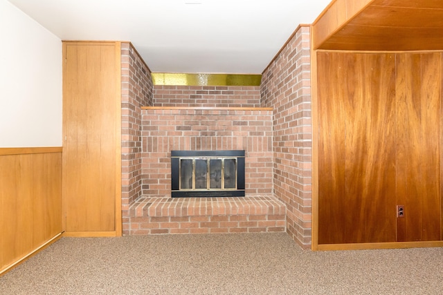 36067 Rolf St, Westland, MI 48186 - unfurnished living room with carpet, wood walls, and a brick fireplace