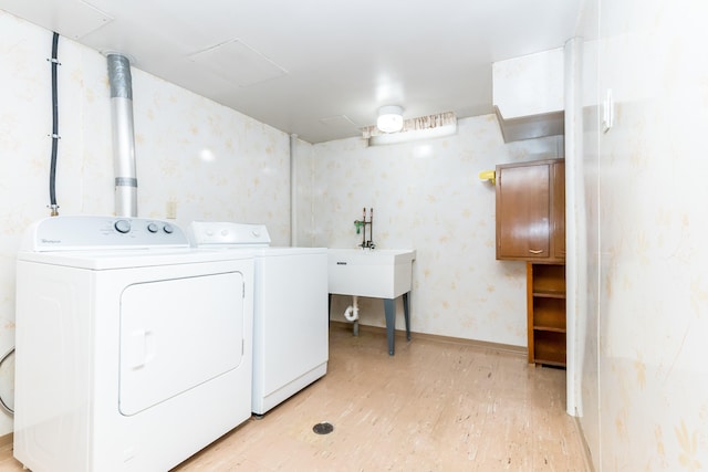 36067 Rolf St, Westland, MI 48186 - laundry area with washing machine and dryer, light wood-style floors, and wallpapered walls