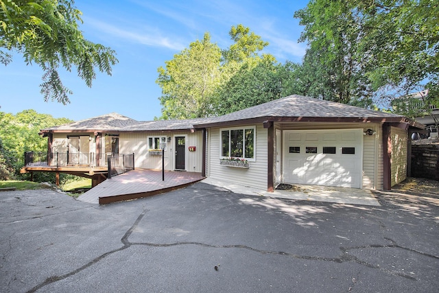3536 Tamsin Ave, Kalamazoo, MI 49008 - single story home with an attached garage, a wooden deck, and asphalt driveway
