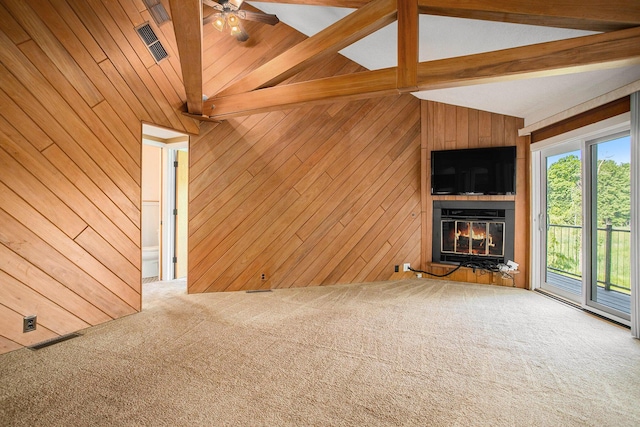 3536 Tamsin Ave, Kalamazoo, MI 49008 - unfurnished living room with wood walls, a fireplace, carpet flooring, and ceiling fan