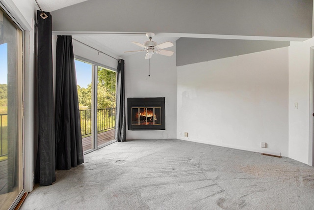 3536 Tamsin Ave, Kalamazoo, MI 49008 - unfurnished living room featuring vaulted ceiling, carpet flooring, a ceiling fan, and a glass covered fireplace