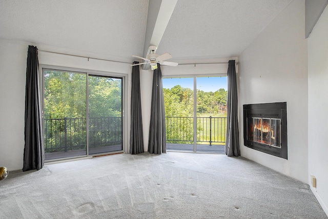 3536 Tamsin Ave, Kalamazoo, MI 49008 - unfurnished room featuring carpet flooring, a textured ceiling, a glass covered fireplace, and a ceiling fan