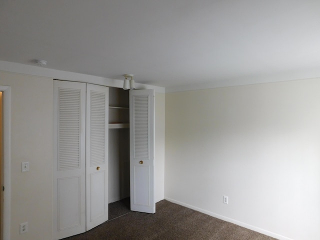 448 Fox Hills Dr S Unit 3, Bloomfield Hills, MI 48304 - unfurnished bedroom featuring dark carpet and a closet