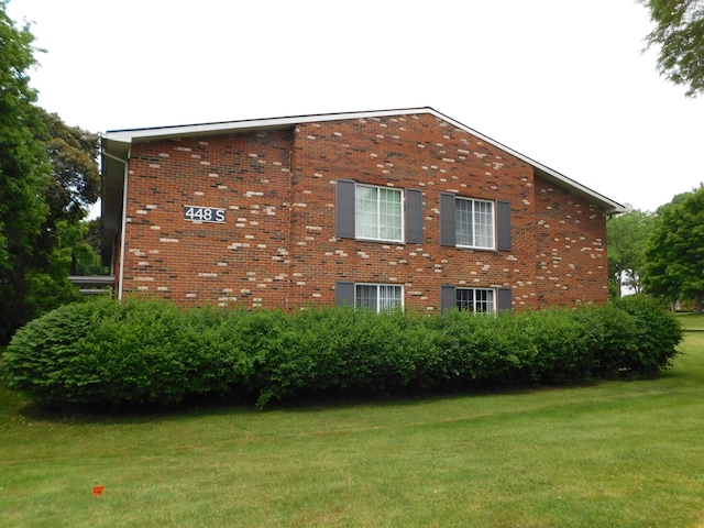 448 Fox Hills Dr S Unit 3, Bloomfield Hills, MI 48304 - view of home's exterior featuring a yard and brick siding