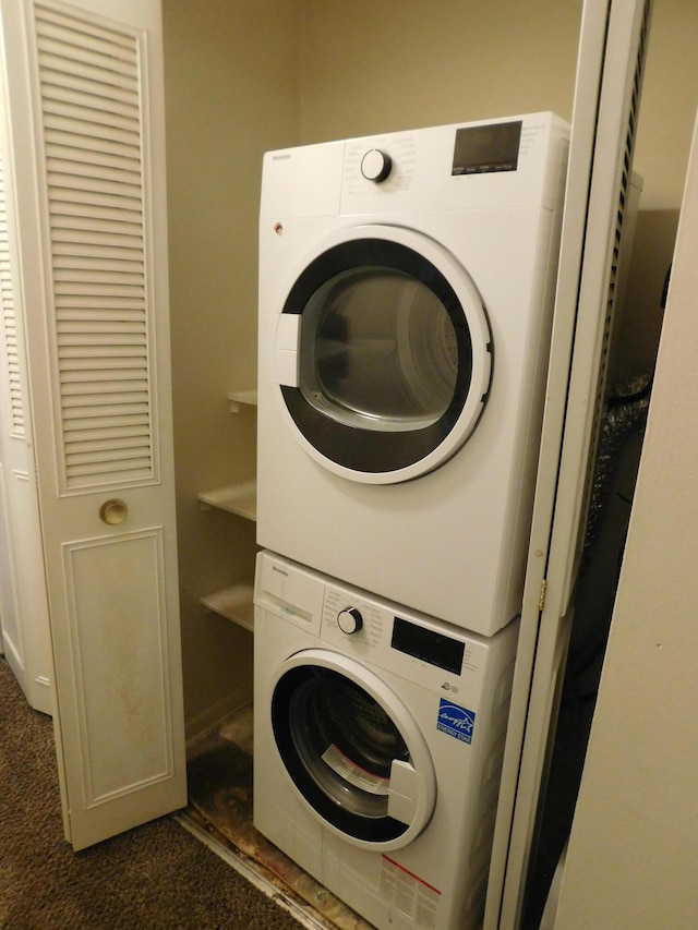 448 Fox Hills Dr S Unit 3, Bloomfield Hills, MI 48304 - laundry area featuring stacked washer and clothes dryer and dark colored carpet