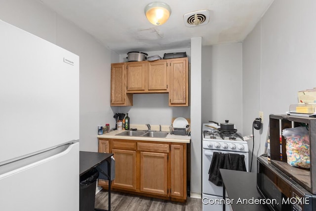 1523 Broadway Ave NW, Grand Rapids, MI 49504 - kitchen with white appliances, wood finished floors, and light countertops