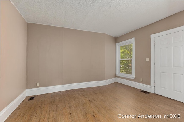 1523 Broadway Ave NW, Grand Rapids, MI 49504 - empty room featuring wood finished floors and a textured ceiling