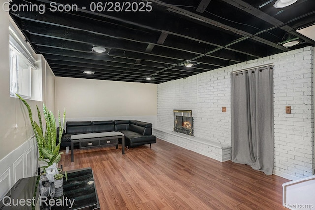181 S Josephine Ave, Pontiac, MI 48341 - living area featuring a fireplace, brick wall, wood finished floors, and a wainscoted wall