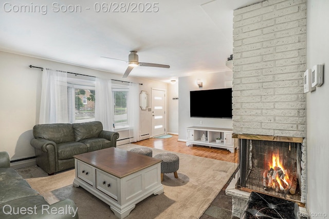 181 S Josephine Ave, Pontiac, MI 48341 - living area featuring a ceiling fan, a brick fireplace, a baseboard heating unit, and a baseboard radiator