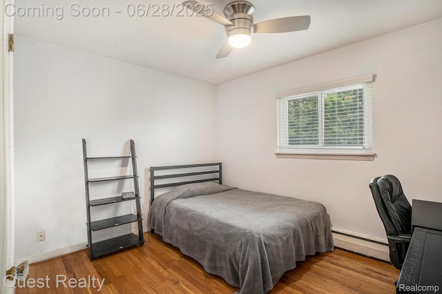 181 S Josephine Ave, Pontiac, MI 48341 - bedroom with baseboard heating, wood finished floors, a ceiling fan, and a desk