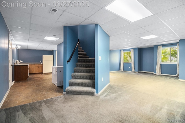 832 Townsend Dr, South Lyon, MI 48178 - basement featuring freestanding refrigerator, a drop ceiling, stairs, and carpet floors