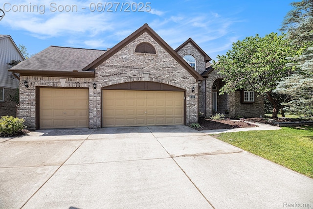 832 Townsend Dr, South Lyon, MI 48178 - french provincial home featuring concrete driveway, a garage, brick siding, and roof with shingles