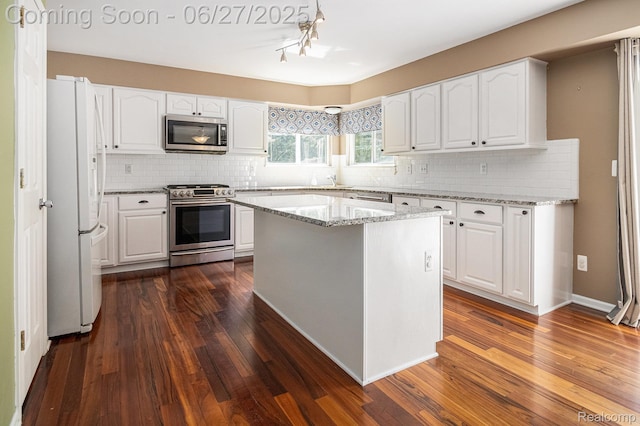 832 Townsend Dr, South Lyon, MI 48178 - kitchen with stainless steel appliances, dark wood finished floors, and white cabinetry