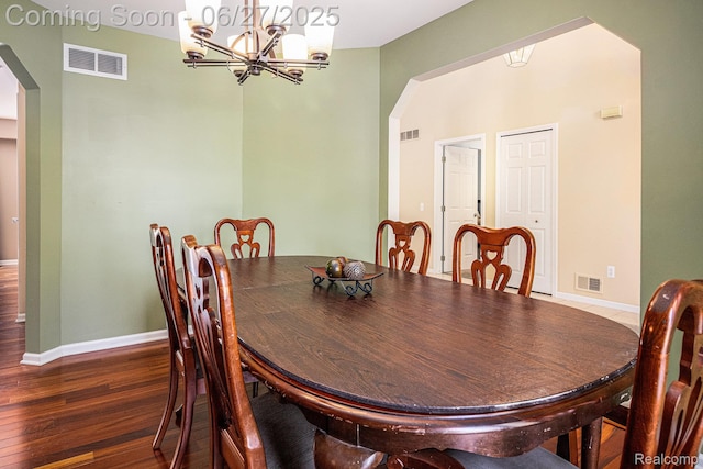 832 Townsend Dr, South Lyon, MI 48178 - dining room with arched walkways, a chandelier, and wood finished floors