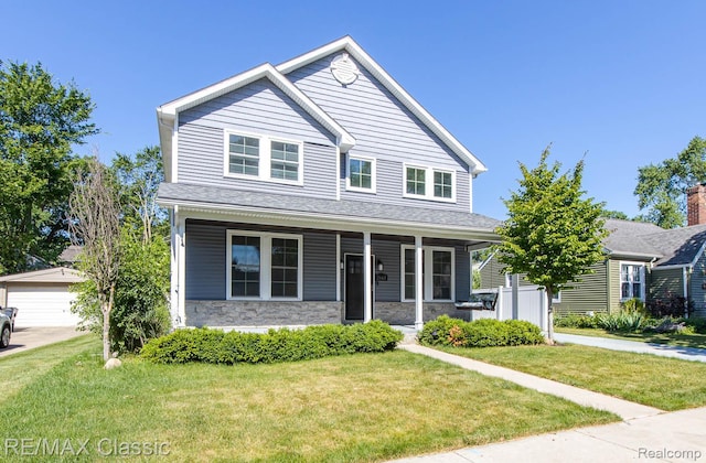 2663 Griffith Ave, Berkley, MI 48072 - view of front of property with covered porch, stone siding, a front yard, and an outbuilding