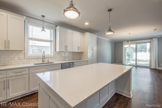 2663 Griffith Ave, Berkley, MI 48072 - kitchen with a kitchen island, backsplash, white cabinetry, dishwasher, and dark wood-style flooring