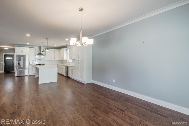 2663 Griffith Ave, Berkley, MI 48072 - kitchen featuring stainless steel appliances, wall chimney range hood, a chandelier, a kitchen island, and light countertops