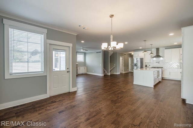 2663 Griffith Ave, Berkley, MI 48072 - kitchen featuring stainless steel appliances, wall chimney exhaust hood, a chandelier, a kitchen island, and ornamental molding