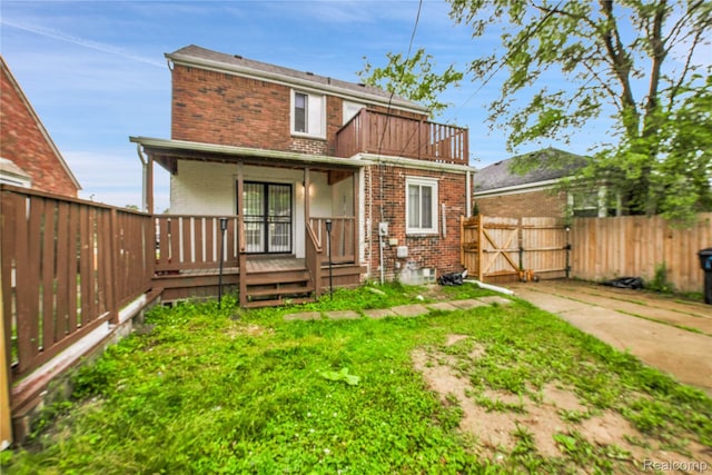 10825 E Outer Dr, Detroit, MI 48224 - rear view of property with brick siding, a gate, a porch, and a balcony