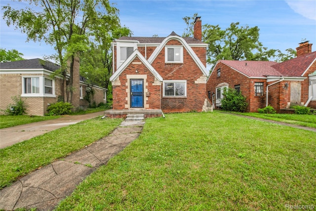 10825 E Outer Dr, Detroit, MI 48224 - english style home with brick siding, a front lawn, and a chimney