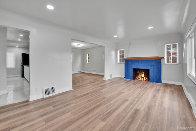 10825 E Outer Dr, Detroit, MI 48224 - unfurnished living room with a fireplace, recessed lighting, and wood finished floors
