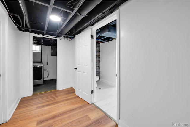 10825 E Outer Dr, Detroit, MI 48224 - hallway with washer / clothes dryer and light wood-style flooring