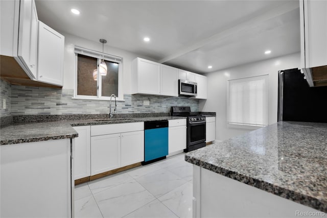 10825 E Outer Dr, Detroit, MI 48224 - kitchen featuring dishwashing machine, stainless steel microwave, gas stove, freestanding refrigerator, and white cabinetry
