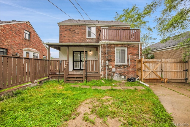 10825 E Outer Dr, Detroit, MI 48224 - rear view of house featuring brick siding, a gate, and covered porch