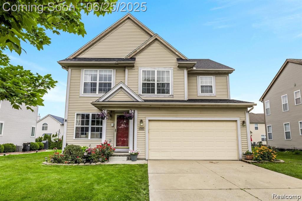 25228 Independence Trl, Warren, MI 48089 - traditional-style house with a front lawn, a garage, and driveway