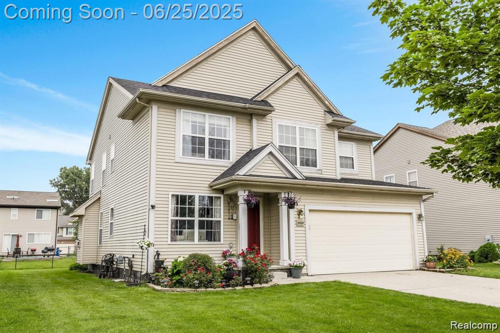 25228 Independence Trl, Warren, MI 48089 - traditional home with a front lawn, driveway, and a garage