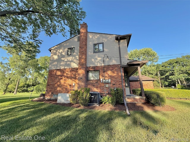 2546 Limerick Ln, Troy, MI 48098 - back of property with a yard, a chimney, and brick siding