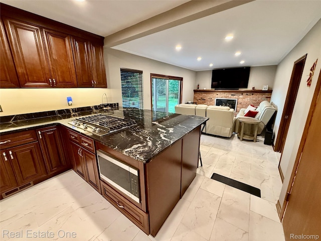2546 Limerick Ln, Troy, MI 48098 - kitchen with light marble finish flooring, stainless steel appliances, a peninsula, a fireplace, and recessed lighting