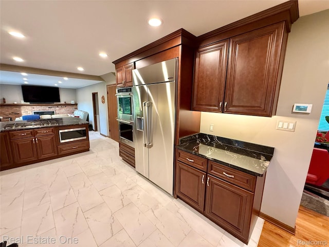 2546 Limerick Ln, Troy, MI 48098 - kitchen featuring built in appliances, dark stone countertops, recessed lighting, light marble finish flooring, and open floor plan