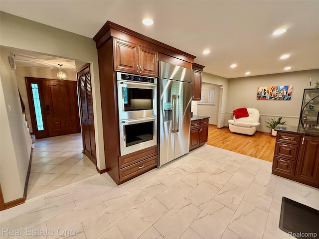2546 Limerick Ln, Troy, MI 48098 - kitchen featuring stainless steel appliances, light marble finish flooring, recessed lighting, and dark stone counters