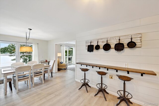 6201 Academy Dr, Brighton, MI 48116 - dining area with light wood finished floors and wood walls