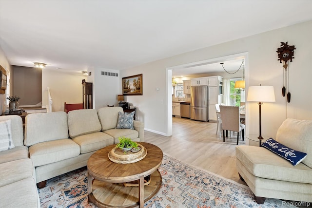 6201 Academy Dr, Brighton, MI 48116 - living area with light wood-style floors and baseboards