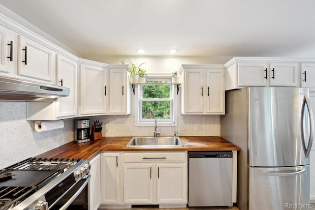 6201 Academy Dr, Brighton, MI 48116 - kitchen with stainless steel appliances, wood counters, under cabinet range hood, and white cabinets