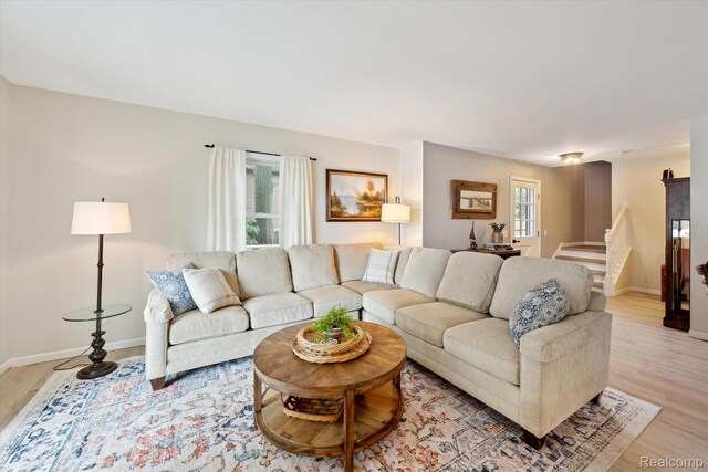 6201 Academy Dr, Brighton, MI 48116 - living room featuring light wood-type flooring and stairs