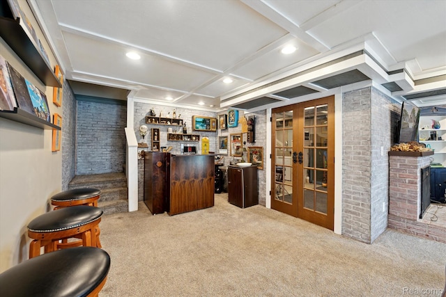 6201 Academy Dr, Brighton, MI 48116 - indoor dry bar featuring carpet flooring, recessed lighting, coffered ceiling, a wood stove, and french doors
