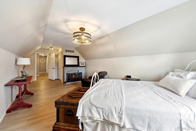 6201 Academy Dr, Brighton, MI 48116 - bedroom with light wood-style floors and lofted ceiling