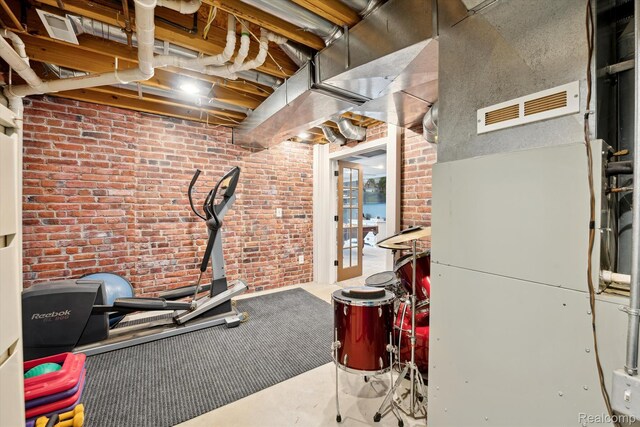 6201 Academy Dr, Brighton, MI 48116 - workout area featuring heating unit and brick wall
