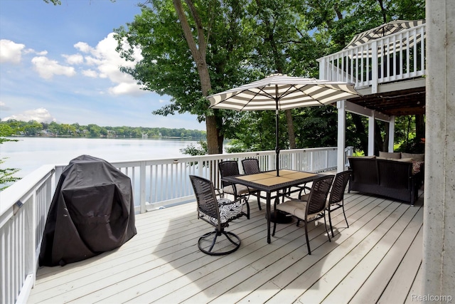 6201 Academy Dr, Brighton, MI 48116 - wooden deck with outdoor dining area, area for grilling, a water view, and an outdoor living space