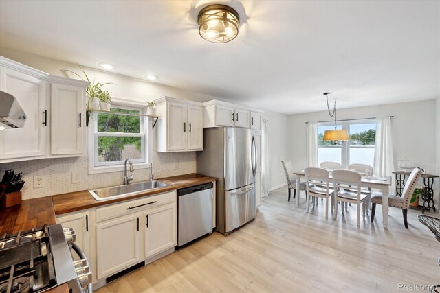 6201 Academy Dr, Brighton, MI 48116 - kitchen with appliances with stainless steel finishes, wooden counters, plenty of natural light, light wood-type flooring, and recessed lighting