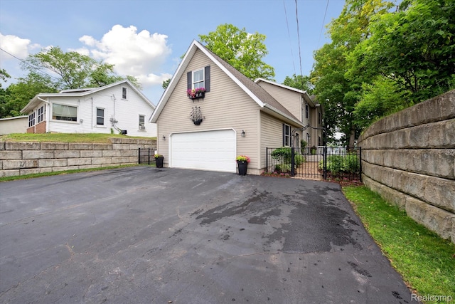 6201 Academy Dr, Brighton, MI 48116 - view of front facade featuring asphalt driveway and an attached garage