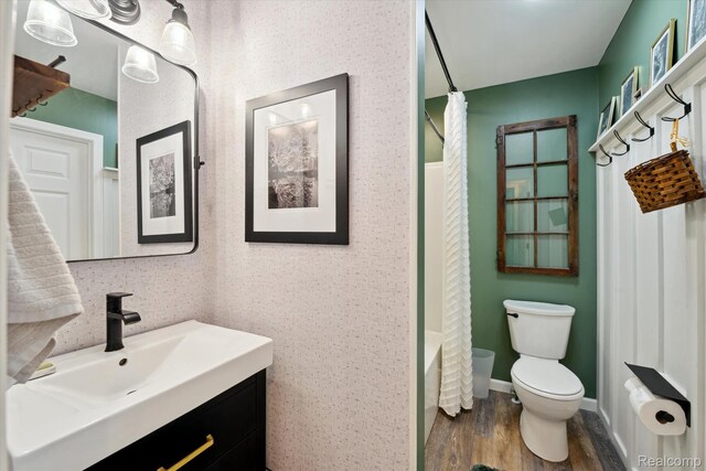 6201 Academy Dr, Brighton, MI 48116 - bathroom with wood finished floors, vanity, and shower / bath combo with shower curtain