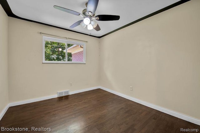 25560 Wexford Ave, Warren, MI 48091 - spare room with dark wood-style floors, ceiling fan, and ornamental molding