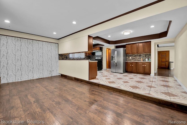 25560 Wexford Ave, Warren, MI 48091 - kitchen with stainless steel fridge with ice dispenser, tasteful backsplash, light wood-style flooring, recessed lighting, and brown cabinetry