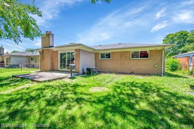 25560 Wexford Ave, Warren, MI 48091 - rear view of property with a chimney, a patio area, and brick siding