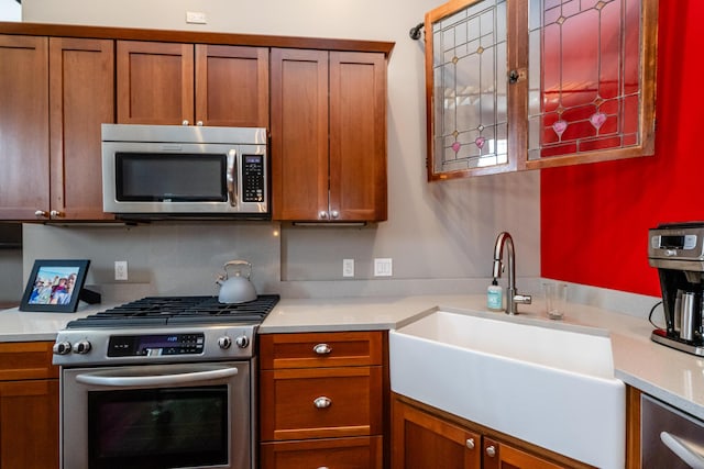 403 State St Unit 6, Saint Joseph, MI 49085 - kitchen featuring stainless steel appliances, light countertops, and brown cabinets